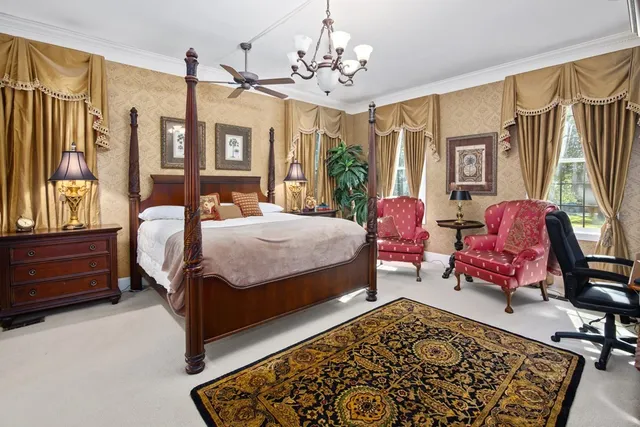 a bedroom with a bed chair and a window