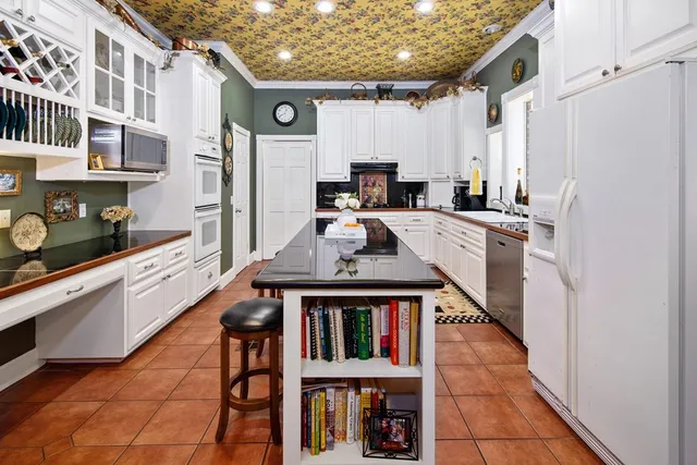 a kitchen with stainless steel appliances granite countertop a stove refrigerator sink and cabinets