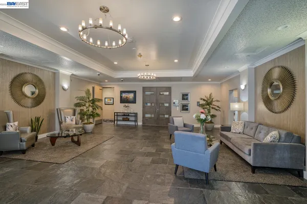 a living room with furniture and a chandelier