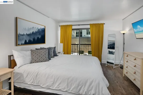 a bedroom with a bed a couch and a window