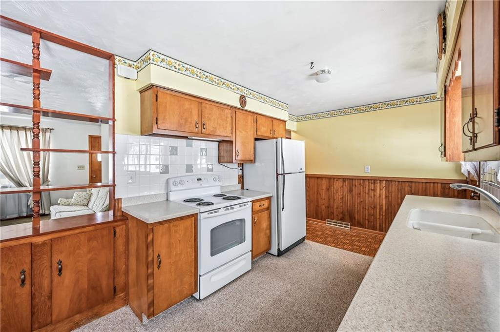2801 Mercer West Middlesex Road West Middlesex, PA 16159 - Photo 12 of 24 a kitchen with stainless steel appliances granite countertop a sink stove and refrigerator