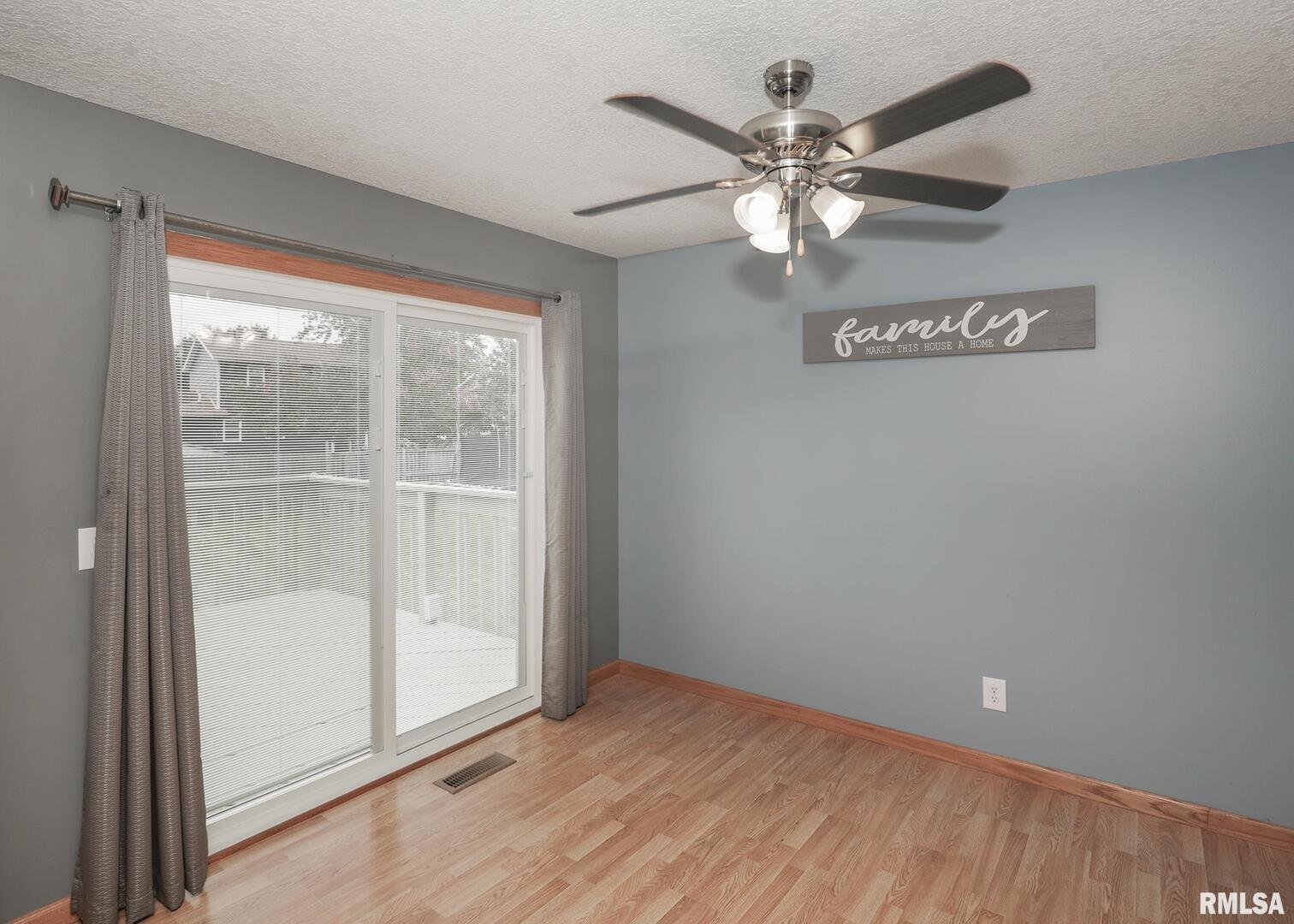 330 Sullivan Drive Colona, IL 61241 - Photo 17 of 31 a view of an empty room with chandelier fan and fire place