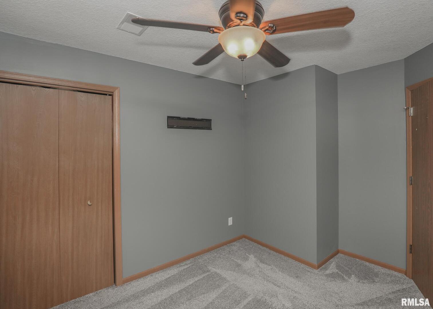 330 Sullivan Drive Colona, IL 61241 - Photo 21 of 31 an empty room with a ceiling fan and a fan