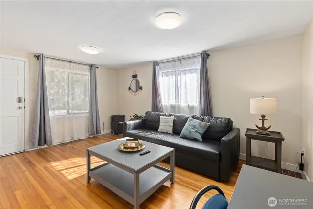 a living room with furniture and wooden floor