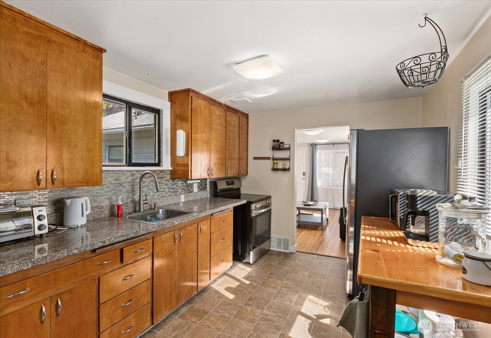 10019 Interlake Avenue North Seattle, WA 98133 - Photo 13 of 20 a large kitchen with stainless steel appliances granite countertop a sink stove and refrigerator