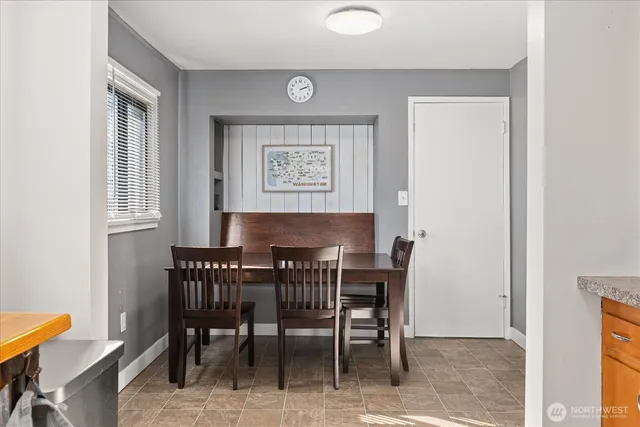 a view of a dining room with furniture and a window