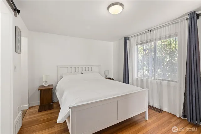 a bed sitting in a bedroom next to a window