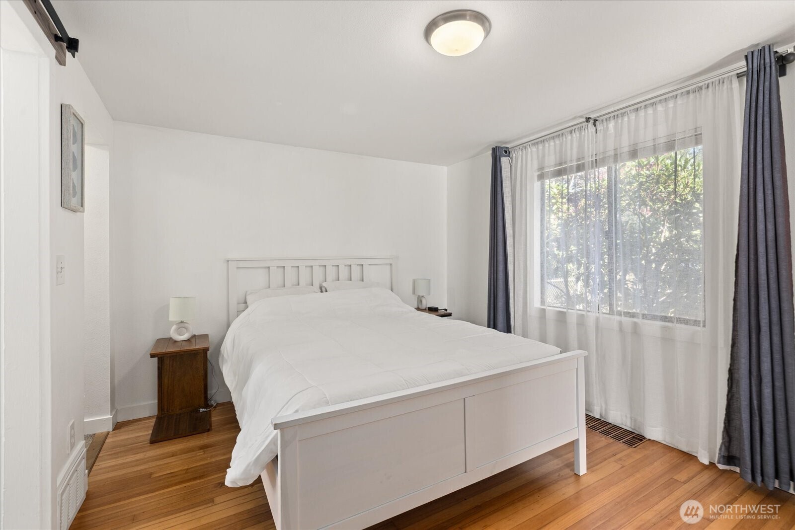 10019 Interlake Avenue North Seattle, WA 98133 - Photo 15 of 20 a bed sitting in a bedroom next to a window