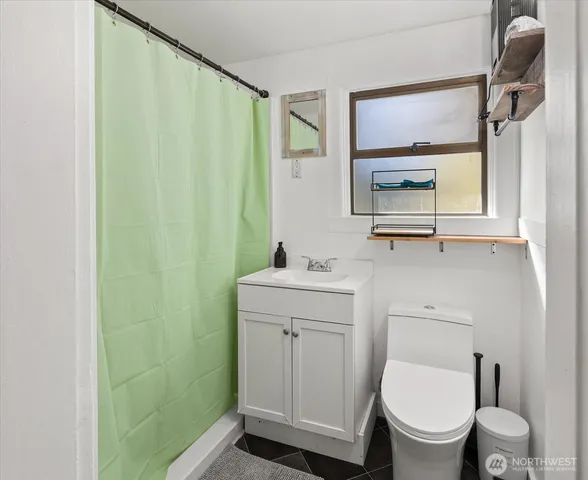 a bathroom with a toilet a sink and a mirror