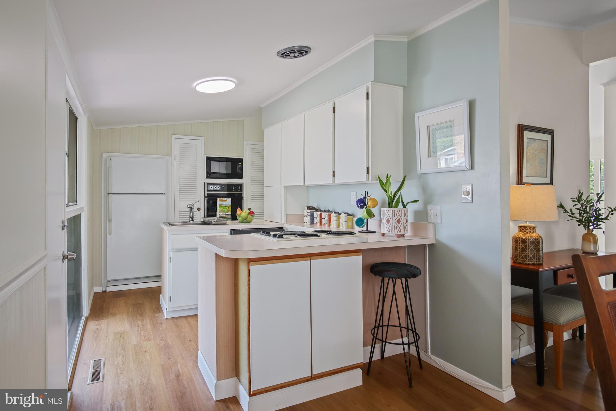 8412 Winands Road Baltimore, MD 21208 - Photo 9 of 26 a kitchen with white cabinets and appliances
