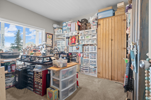 150 West 7500th South, Unit 13 Midvale, UT 84047 - Photo 20 of 32 Room with a large window and horizontal blinds, featuring a built-in wood cabinet with vertical paneling