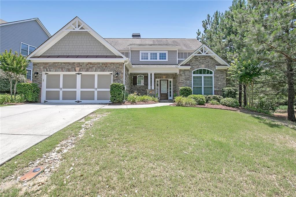 7541 Copper Kettle Way Flowery Branch, GA 30542 - Photo 1 of 1 a front view of a house with a yard and garage