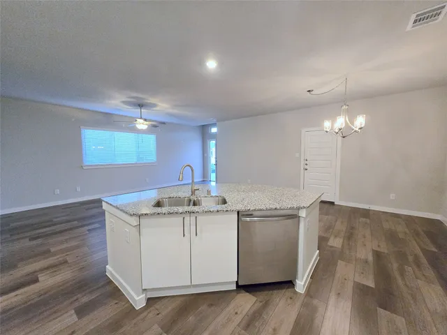 a kitchen with a sink and chandelier