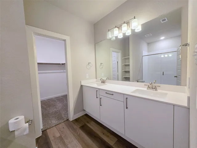 a bathroom with a double vanity sink and a mirror