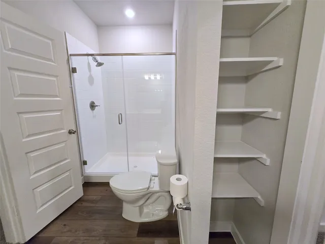 a bathroom with a toilet and a shower