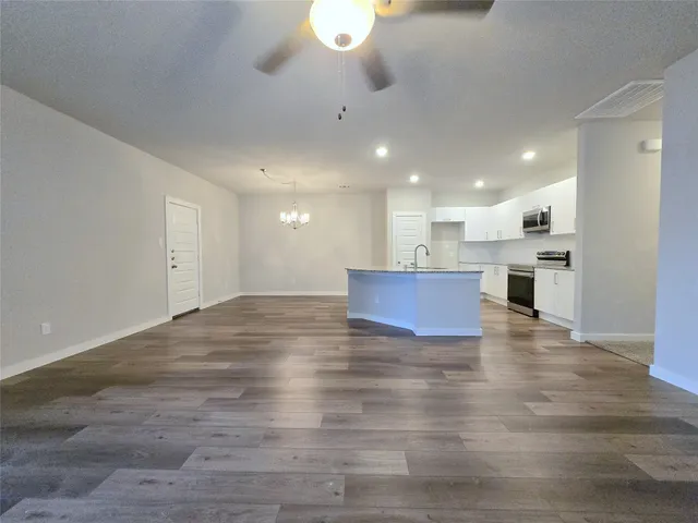 a view of kitchen and a chandelier fan refrigerator