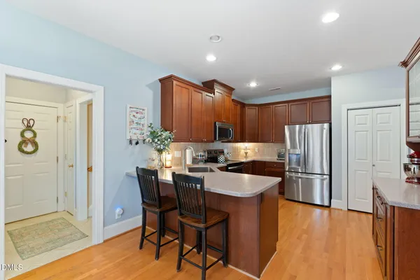 a kitchen with stainless steel appliances granite countertop a refrigerator and a sink