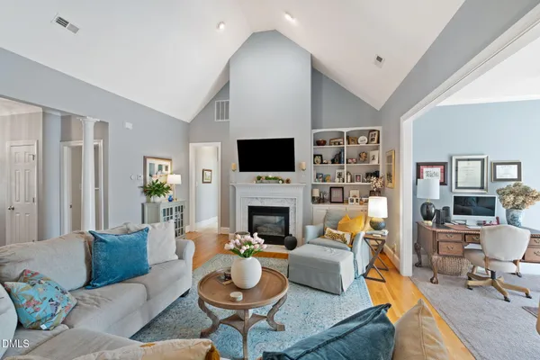 a living room with furniture a fireplace and a flat screen tv