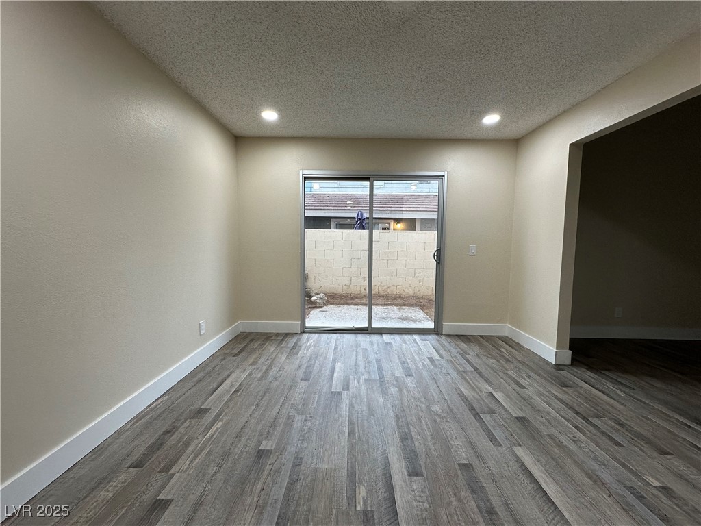 117 Boysenberry Lane Henderson, NV 89074 - Photo 14 of 22 Empty room featuring a textured ceiling, recessed lighting, and wood finished floors
