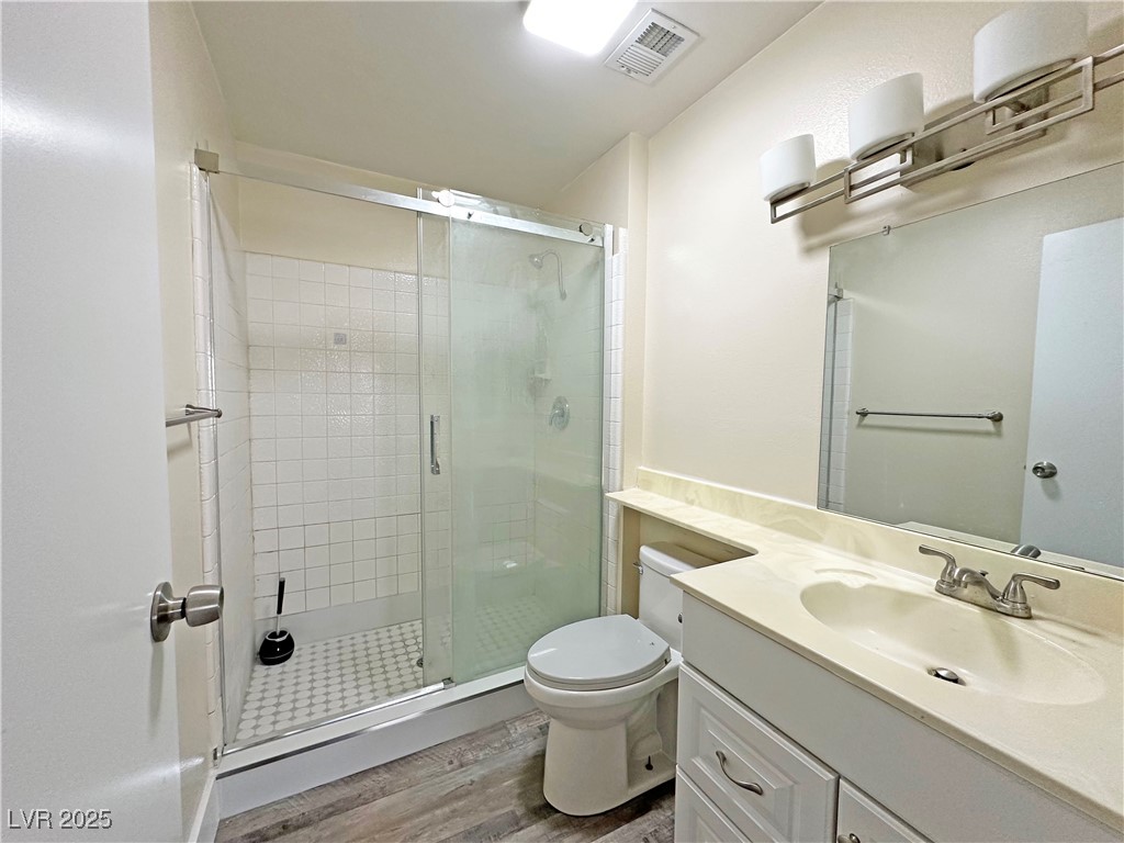 117 Boysenberry Lane Henderson, NV 89074 - Photo 17 of 22 Bathroom featuring a shower stall, light wood-style floors, and vanity