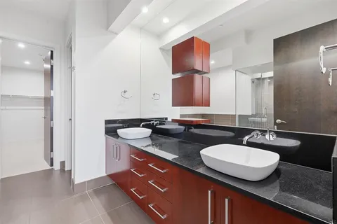 a bathroom with a sink double vanity and a mirror