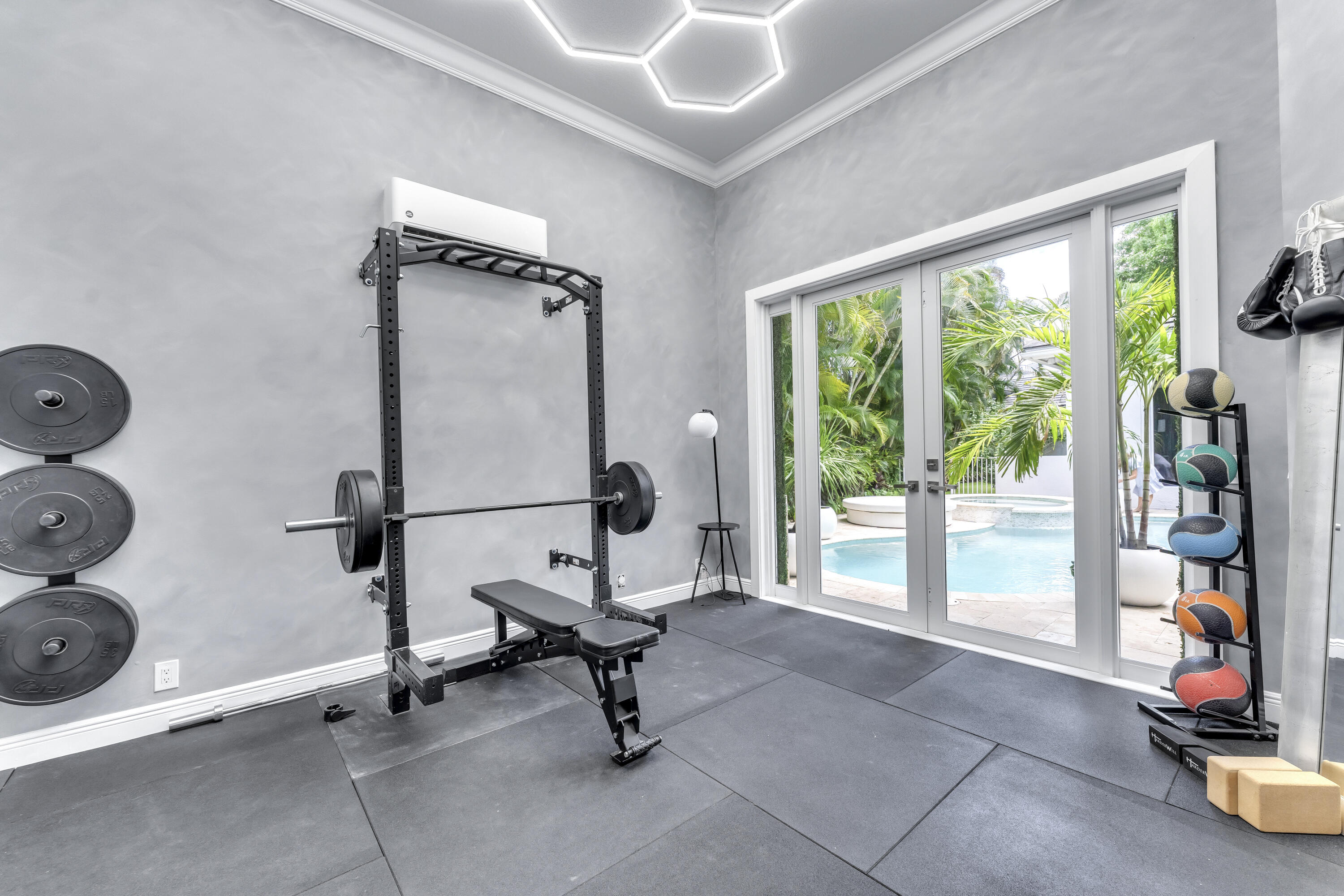 3156 Northwest 61st Street Boca Raton, FL 33496 - Photo 34 of 46 a view of a room with gym equipment and a large window