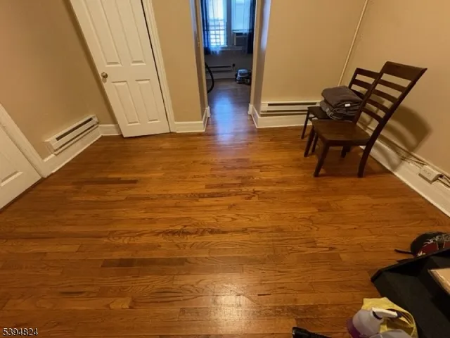 a view of living room with furniture and wooden floor