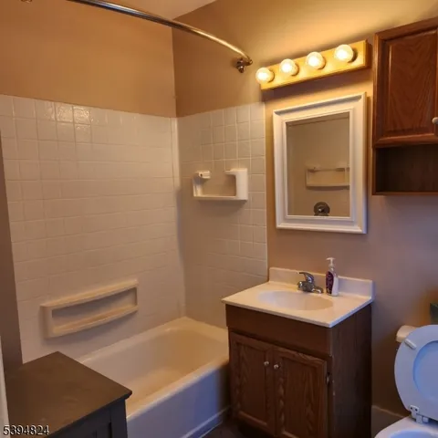 a bathroom with a sink a toilet and mirror