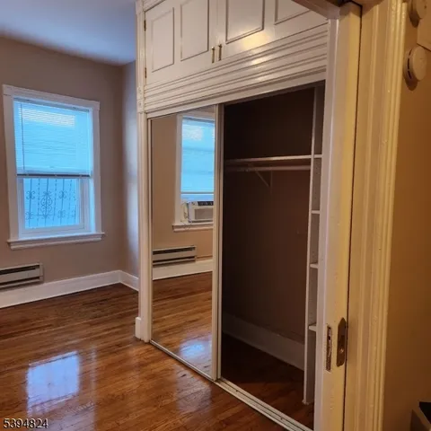 a view of walk in closet with empty room