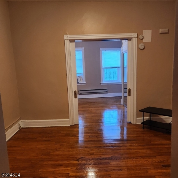9 Moran Street, Unit 2 Newton, NJ 07860 - Photo 7 of 13 a view of hallway with stairs and wooden floor