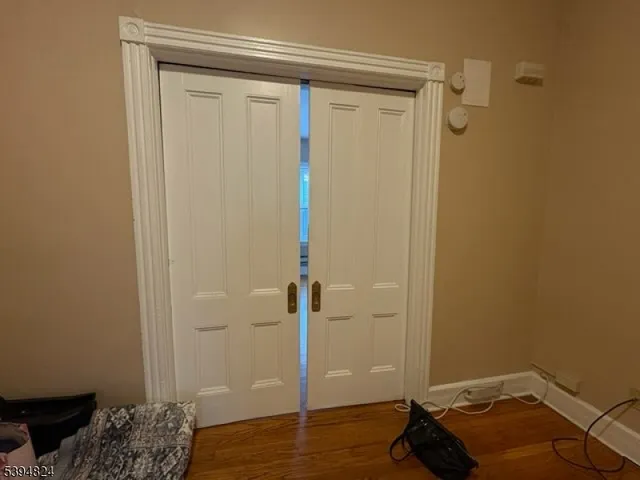 a view of a room with wooden floor