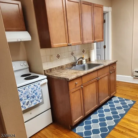 a kitchen with sink cabinets and stove