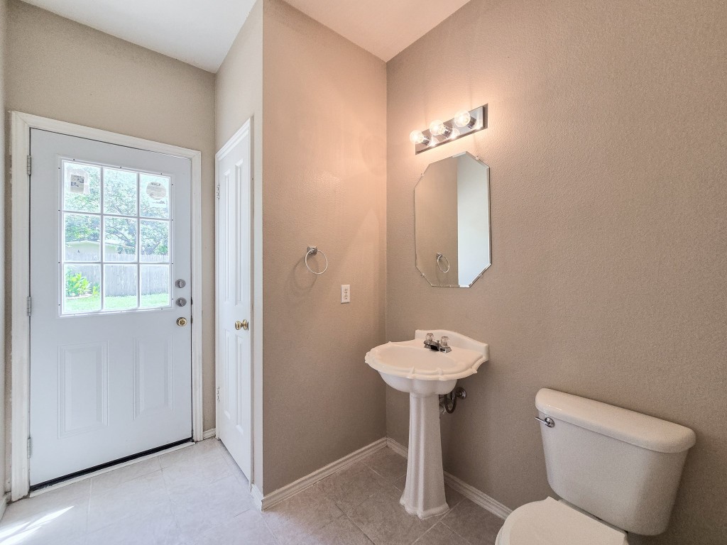 17692 Box Canyon Terrace Round Rock, TX 78681 - Photo 15 of 26 a bathroom with a toilet sink and mirror