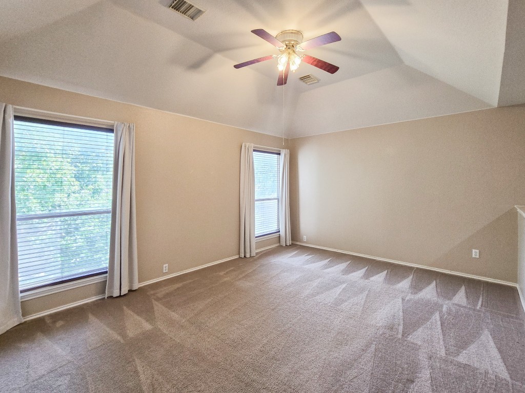 17692 Box Canyon Terrace Round Rock, TX 78681 - Photo 16 of 26 an empty room with chandelier fan and windows