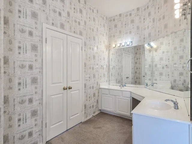 a bathroom with a tub sink and mirror
