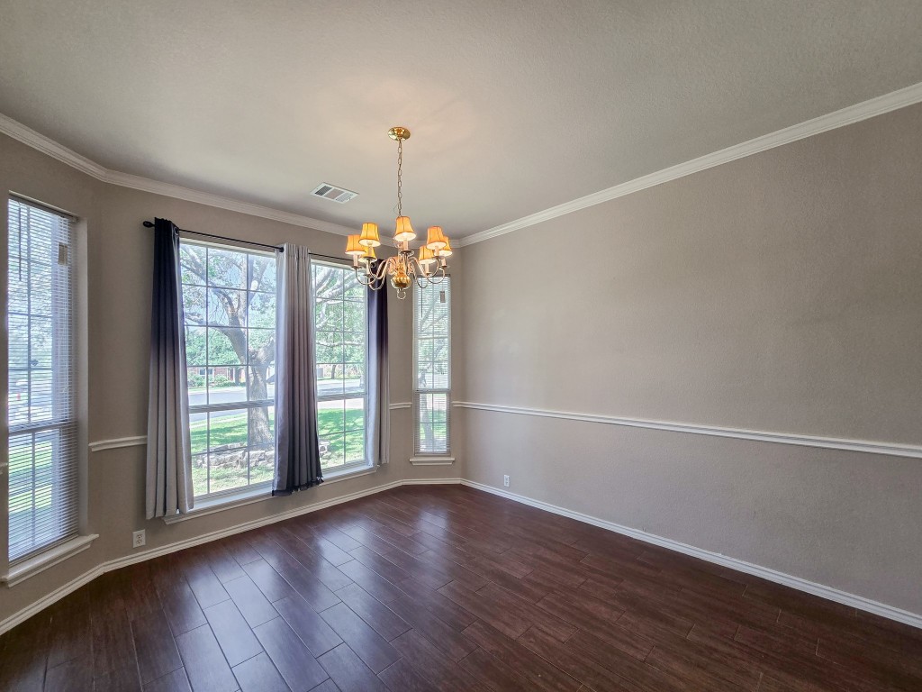 17692 Box Canyon Terrace Round Rock, TX 78681 - Photo 6 of 26 an empty room with wooden floor and windows