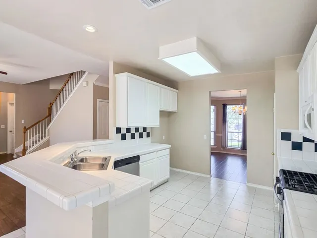 a kitchen with a stove a sink and a refrigerator