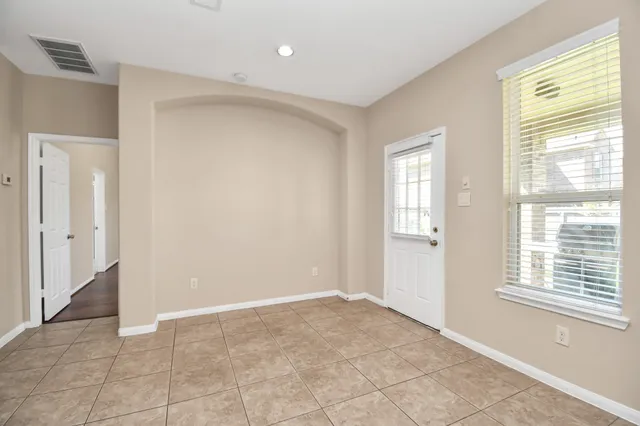 a view of an empty room with a window