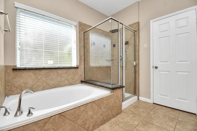a bathroom with a tub and a sink