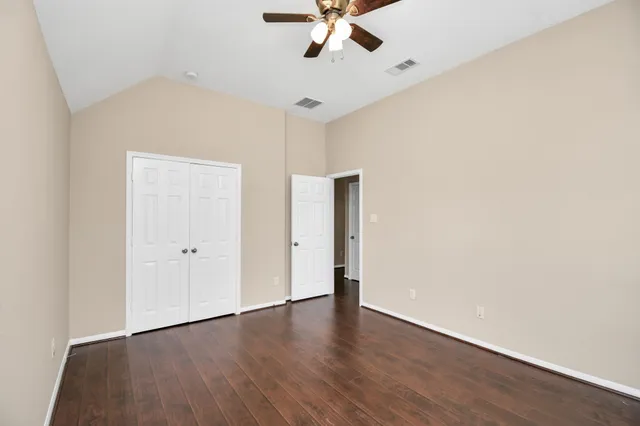 a view of an empty room with a ceiling fan