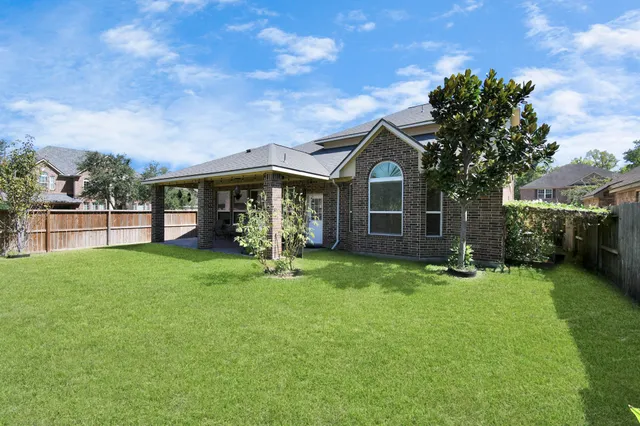 a view of a house with backyard porch and garden