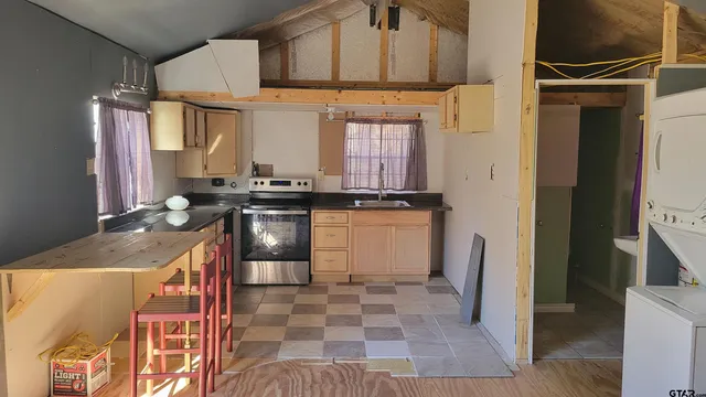 a view of a kitchen with furniture and a kitchen