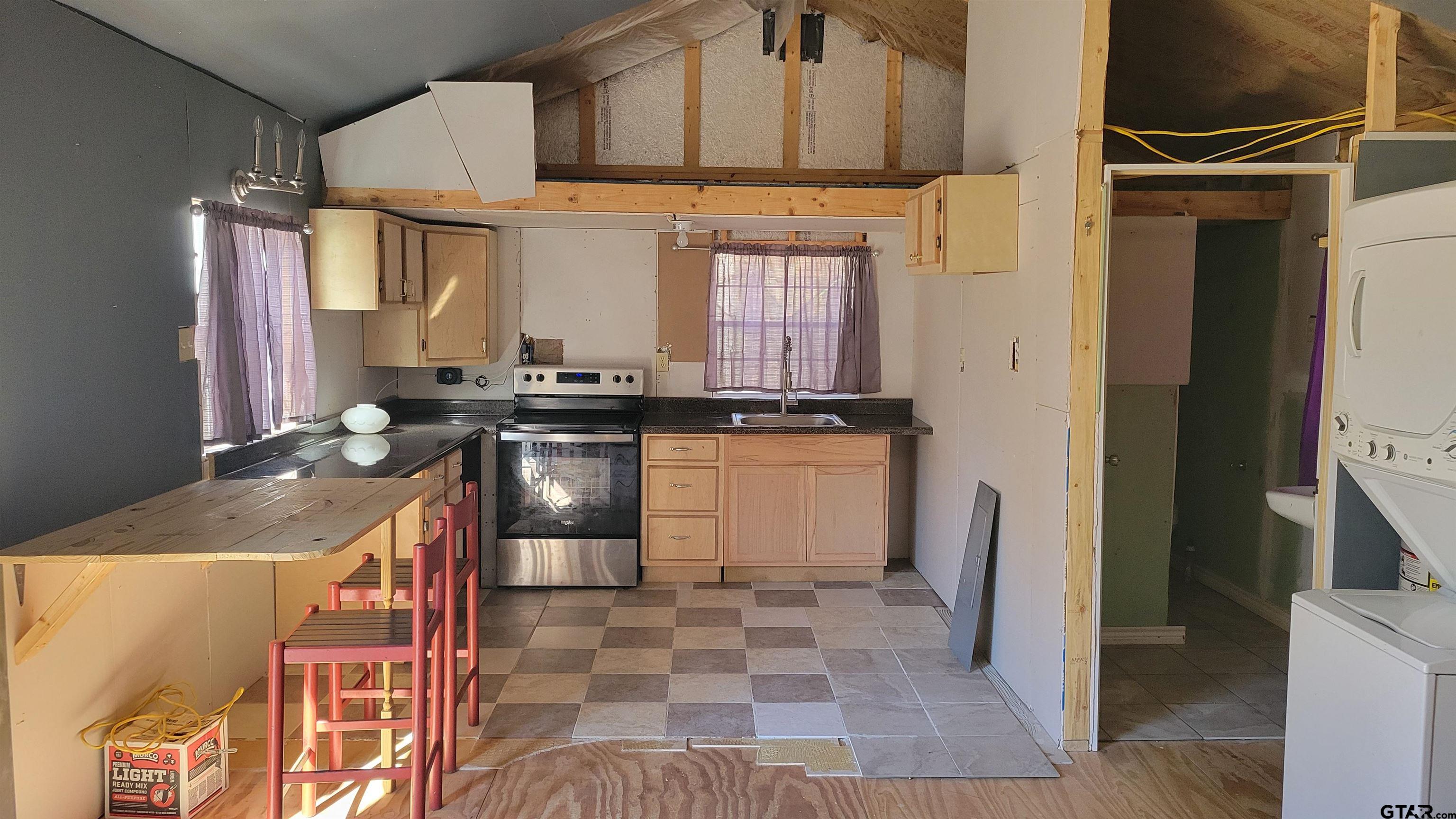 269 County Road 2155 Quitman, TX 75783 - Photo 5 of 15 a kitchen with stainless steel appliances granite countertop a stove a sink and a refrigerator