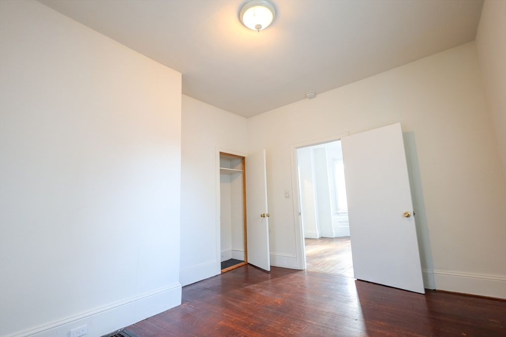 68 Newhall Street, Unit 68 Malden, MA 02148 - Photo 12 of 39 an empty room with wooden floor and windows