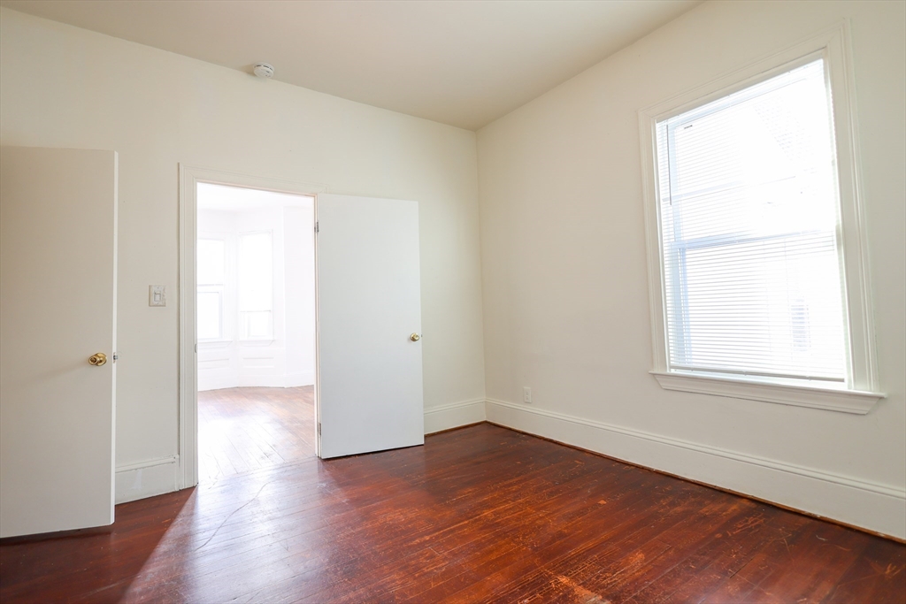 68 Newhall Street, Unit 68 Malden, MA 02148 - Photo 13 of 39 an empty room with wooden floor and windows