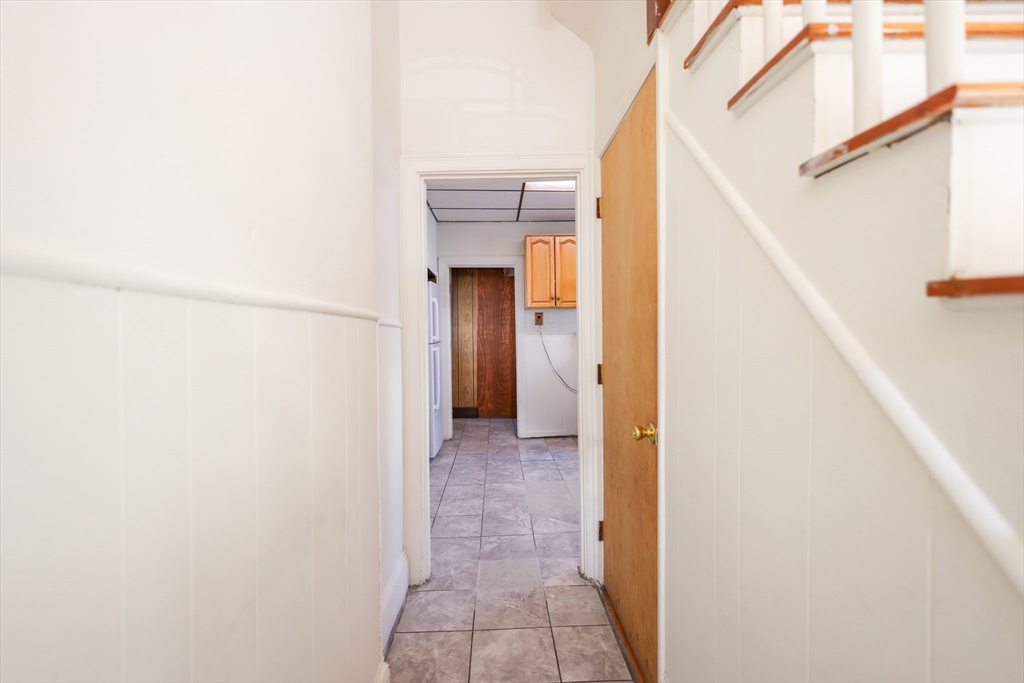 68 Newhall Street, Unit 68 Malden, MA 02148 - Photo 15 of 39 a view of a hallway with wooden shelves