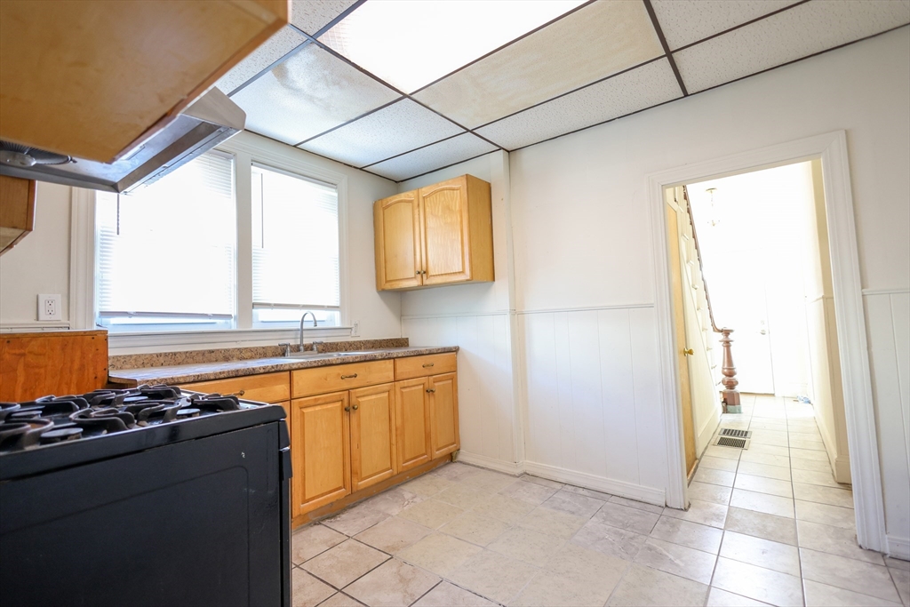 68 Newhall Street, Unit 68 Malden, MA 02148 - Photo 17 of 39 a kitchen with stainless steel appliances granite countertop a sink stove and refrigerator