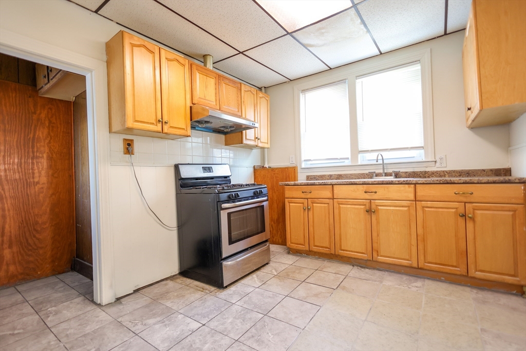 68 Newhall Street, Unit 68 Malden, MA 02148 - Photo 18 of 39 a kitchen with white cabinets and white appliances