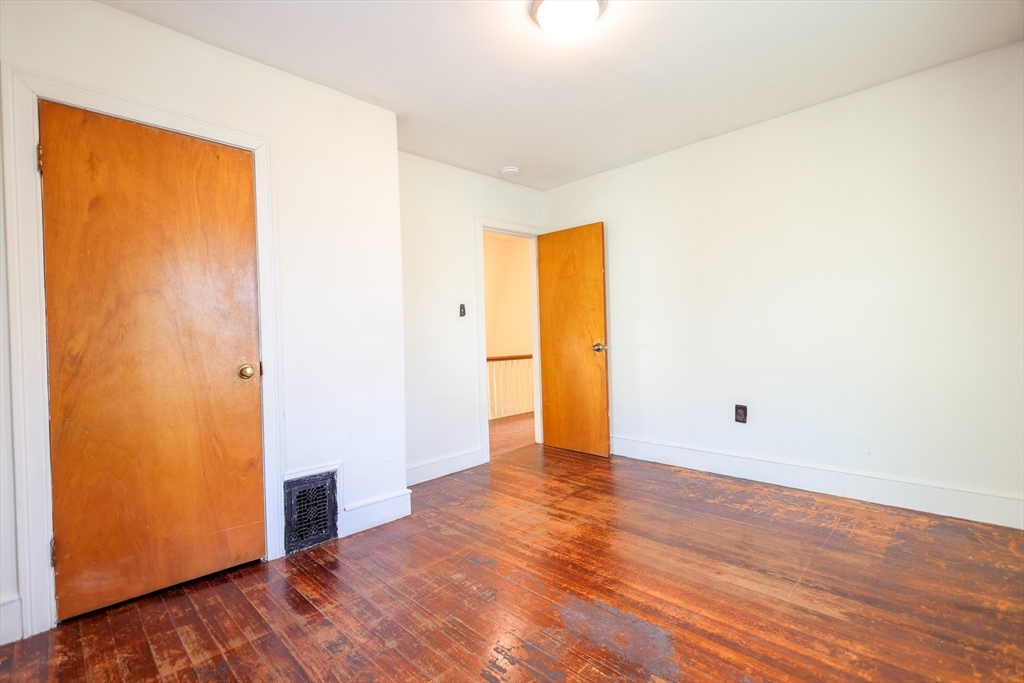 68 Newhall Street, Unit 68 Malden, MA 02148 - Photo 23 of 39 a view of an empty room with wooden floor