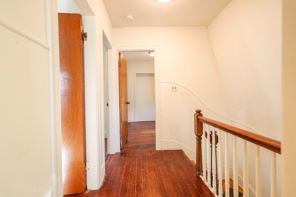 68 Newhall Street, Unit 68 Malden, MA 02148 - Photo 29 of 39 a view of a hallway with wooden floor